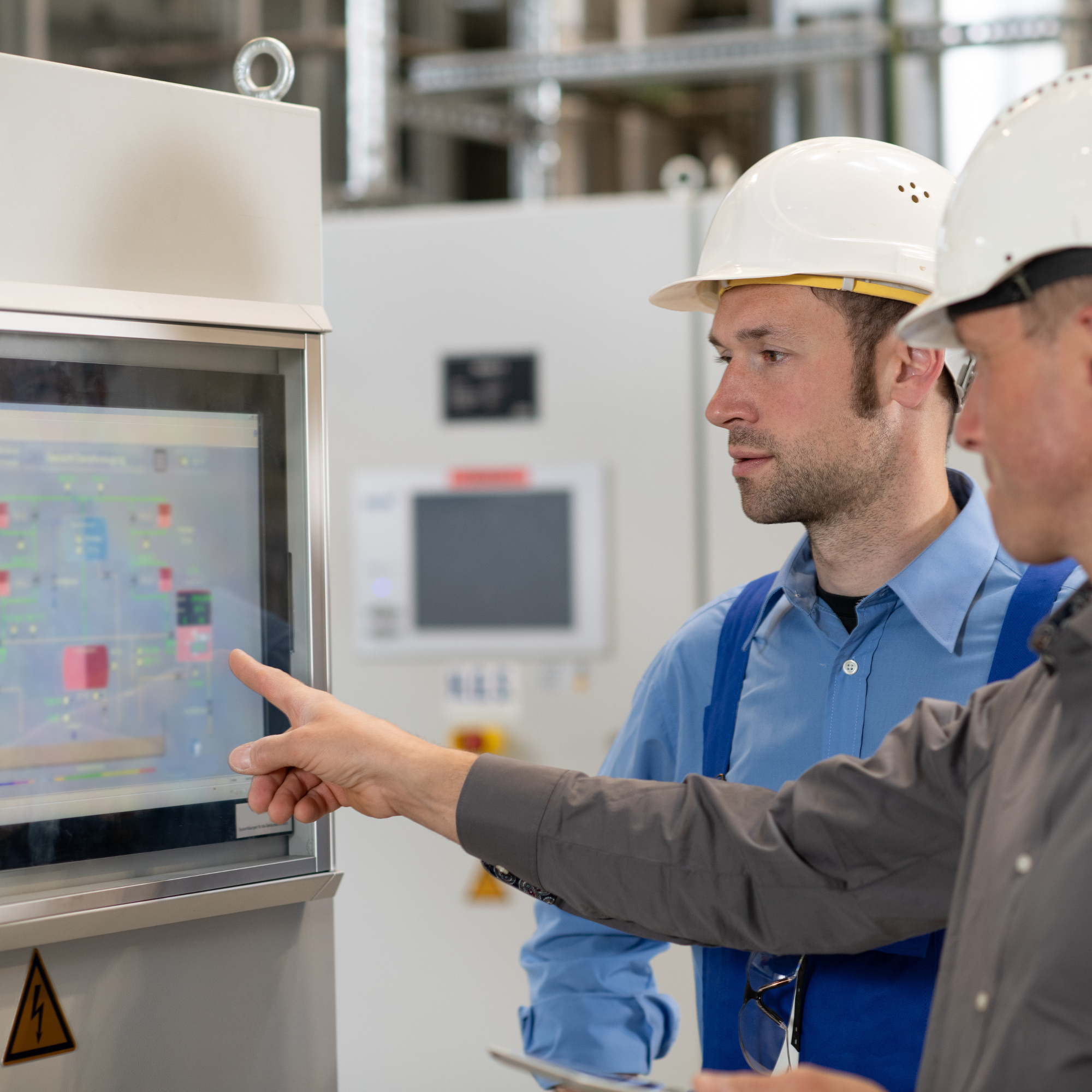 boss with worker in the background in his factory